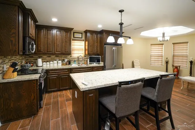 a kitchen with center island table and chairs in it