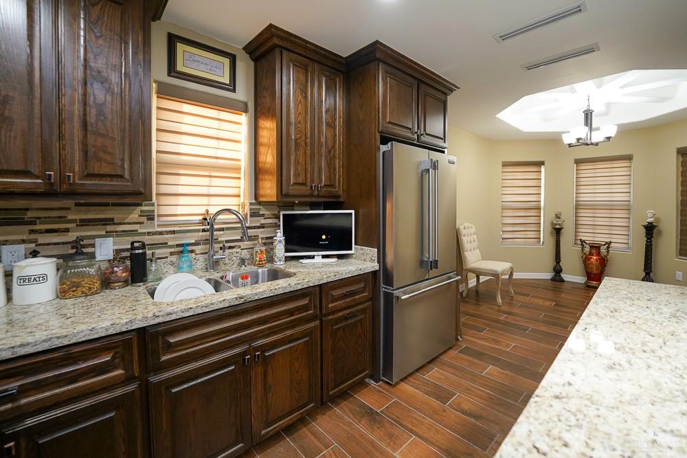1408 Royola Street Mission, TX 78572 - Photo 13 of 42 a kitchen with stainless steel appliances granite countertop a sink stove and refrigerator