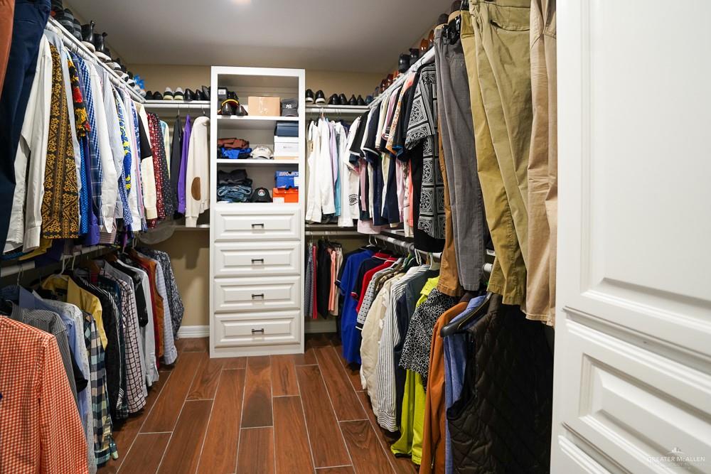 1408 Royola Street Mission, TX 78572 - Photo 24 of 42 a view of walk in closet with clothes and shoes