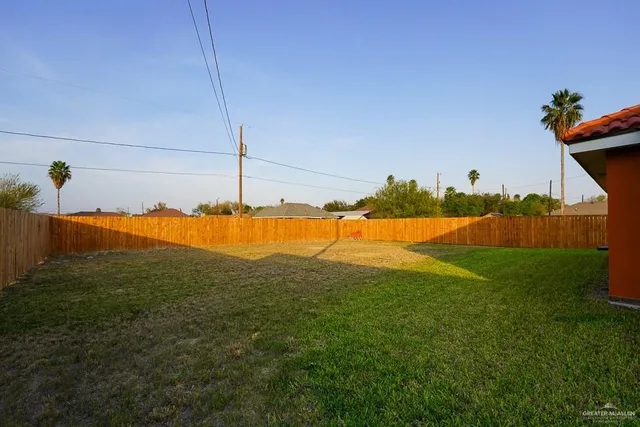 a view of a large garden with plants and large trees