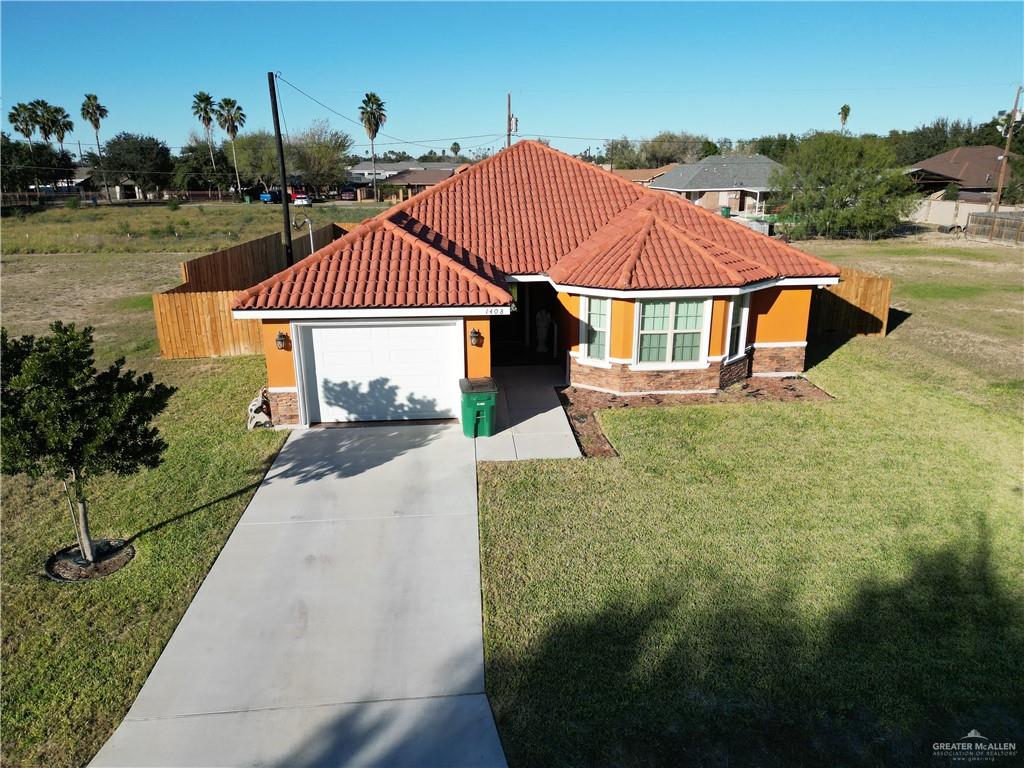 1408 Royola Street Mission, TX 78572 - Photo 35 of 42 a front view of a house with a yard