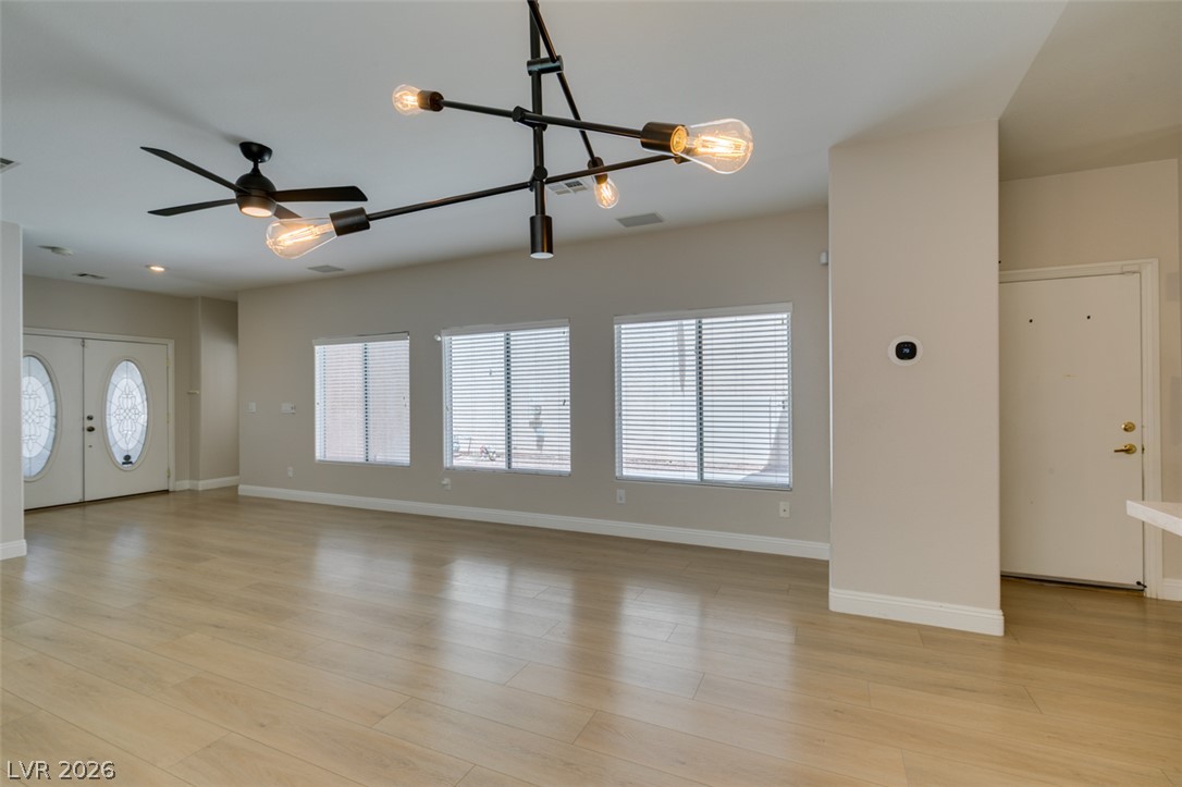 8909 Houston Ridge Avenue Las Vegas, NV 89178 - Photo 12 of 45 Bright, open-concept living area with polished wood flooring and ample natural light.