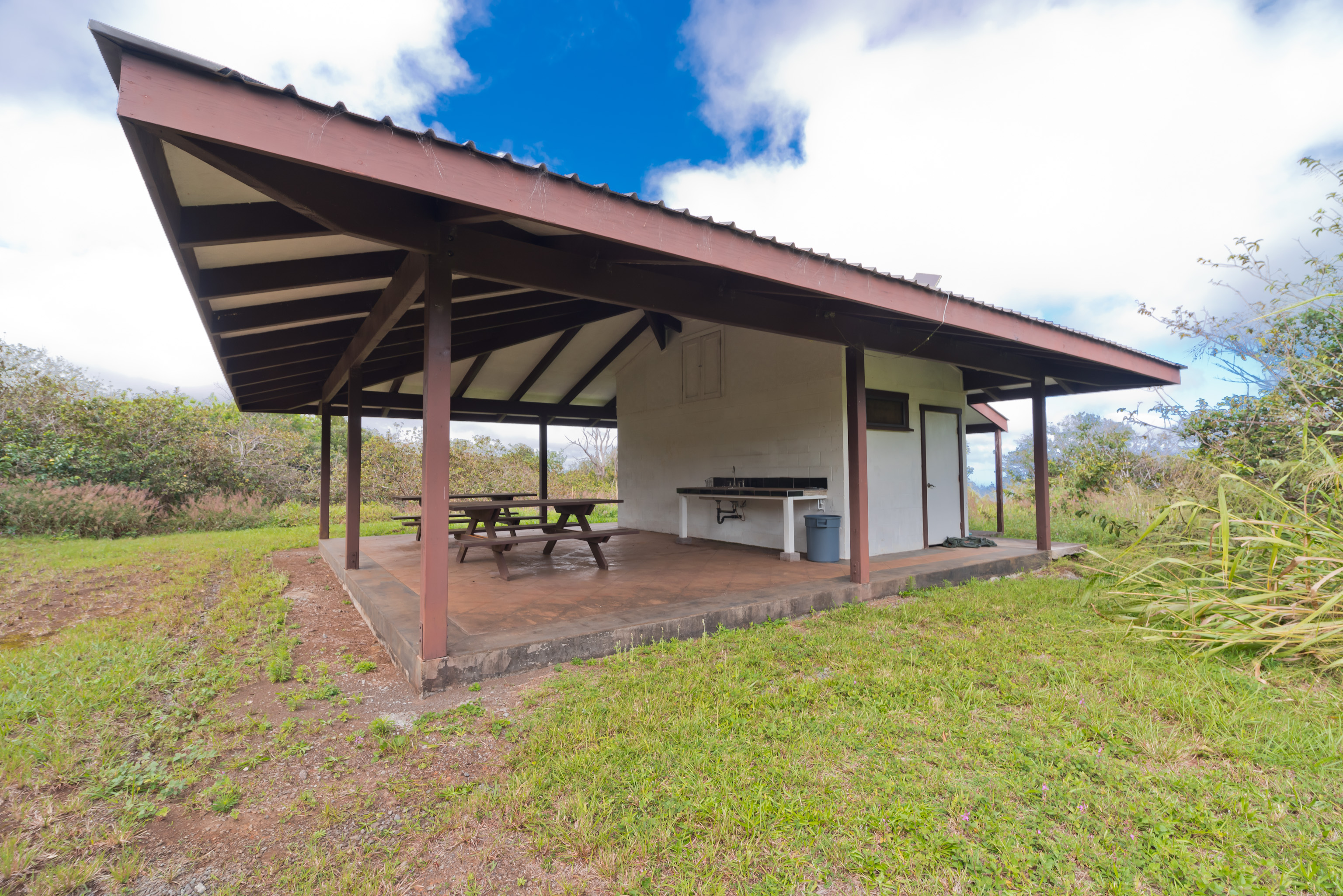 44-3342 Kula Kahiko Road Paauilo, HI 96776 - Photo 6 of 30 a view of a patio with table and chairs under an umbrella with wooden fence