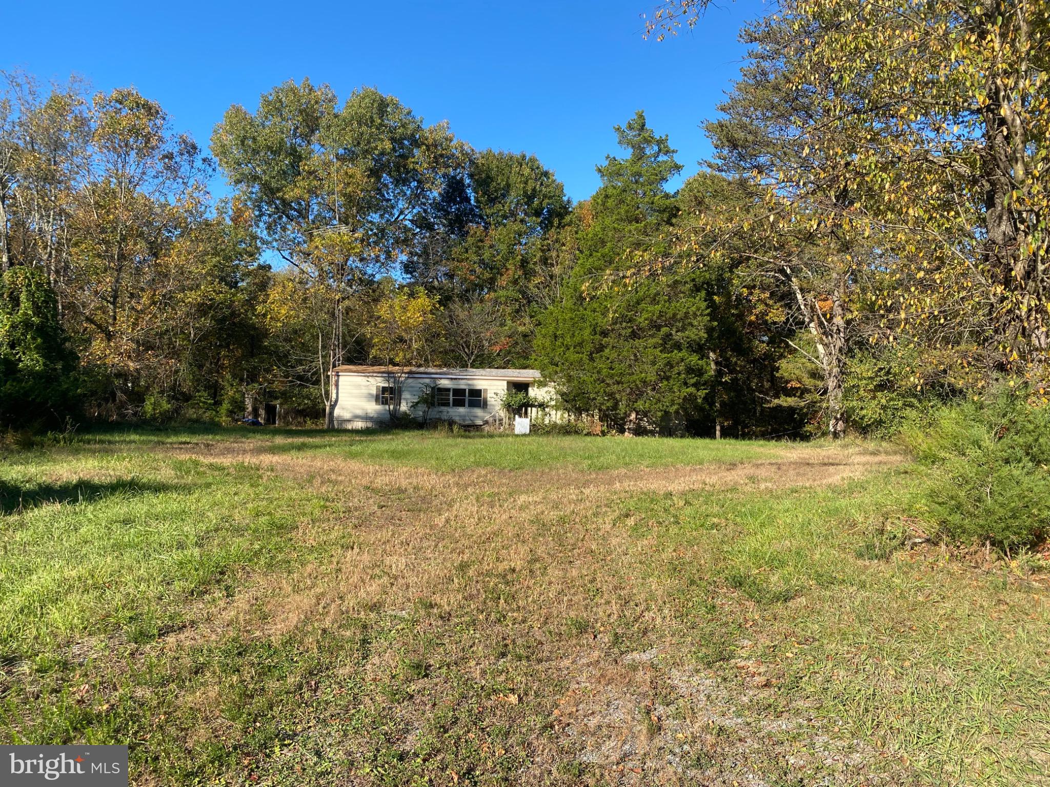 155 Budding Dogwood Road Bunker Hill, WV 25413 - Photo 2 of 20 a view of a field with trees in the background