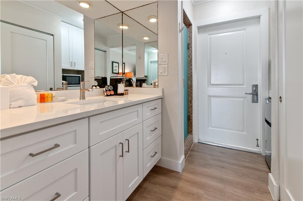 900 Broad Avenue South, Unit 133/134 Naples, FL 34102 - Photo 11 of 37 a bathroom with a double vanity sink mirror and shower