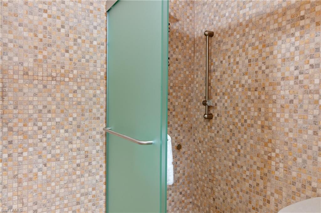 900 Broad Avenue South, Unit 133/134 Naples, FL 34102 - Photo 13 of 37 a bathroom with a shower