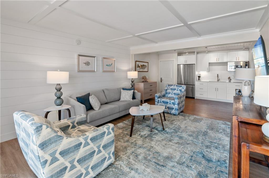 900 Broad Avenue South, Unit 133/134 Naples, FL 34102 - Photo 3 of 37 a living room with furniture and a table