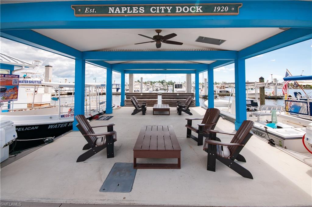 900 Broad Avenue South, Unit 133/134 Naples, FL 34102 - Photo 34 of 37 a living room with furniture and a floor to ceiling window