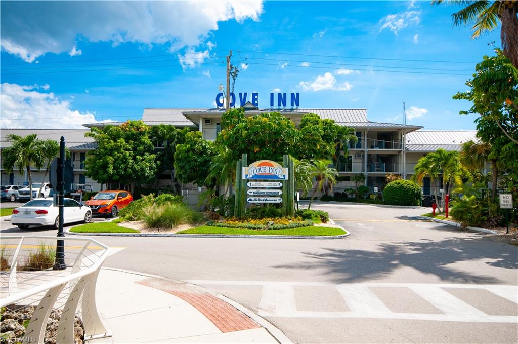 900 Broad Avenue South, Unit 133/134 Naples, FL 34102 - Photo 36 of 37 a view of yellow house with a yard and potted plants