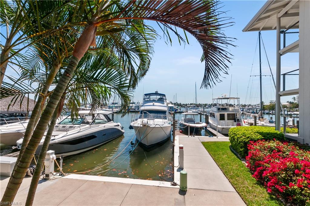 900 Broad Avenue South, Unit 133/134 Naples, FL 34102 - Photo 37 of 37 a view of swimming pool with a table and chairs