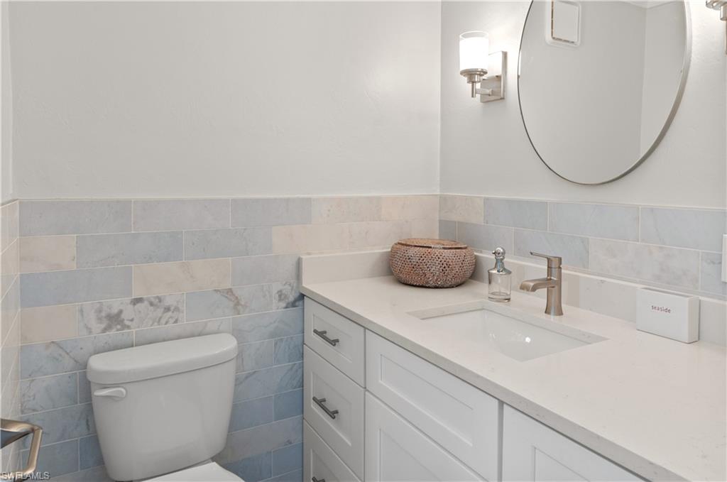 900 Broad Avenue South, Unit 133/134 Naples, FL 34102 - Photo 6 of 37 a bathroom with a sink and a mirror