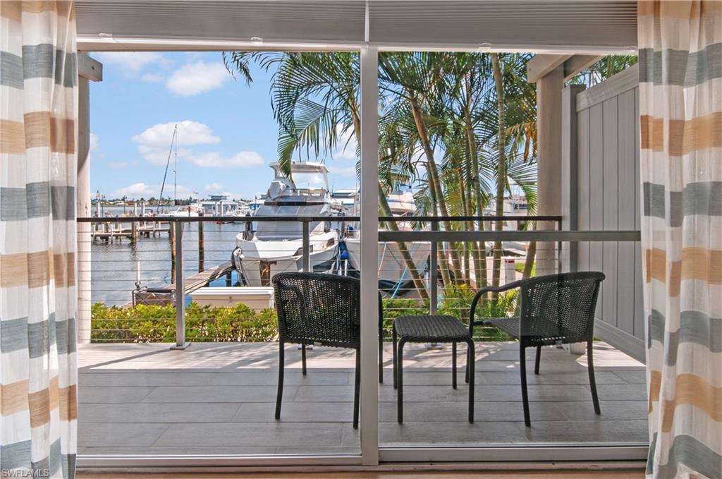 900 Broad Avenue South, Unit 133/134 Naples, FL 34102 - Photo 9 of 37 a view of a chairs and table in the balcony