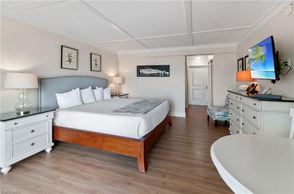 900 Broad Avenue South, Unit 133/134 Naples, FL 34102 - Photo 10 of 37 a bed room with bed and a couch