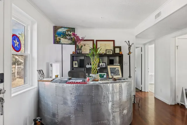 a view of a living room with furniture and a flat screen tv