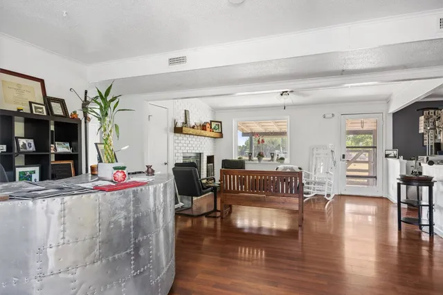 a living room with fireplace furniture and a wooden floor