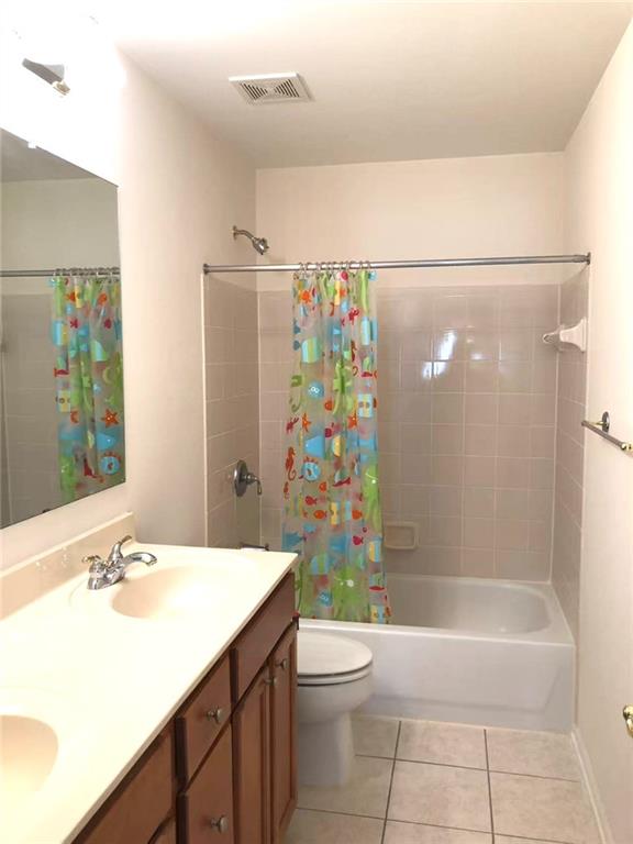 5876 Rue Villa Lane Tucker, GA 30084 - Photo 13 of 17 a bathroom with a sink a toilet and shower