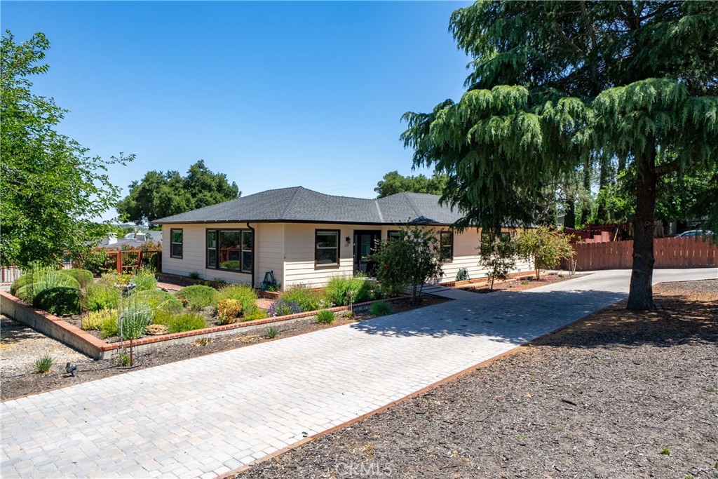 204 18th Street Paso Robles, CA 93446 - Photo 1 of 65 a front view of a house with a yard and potted plants