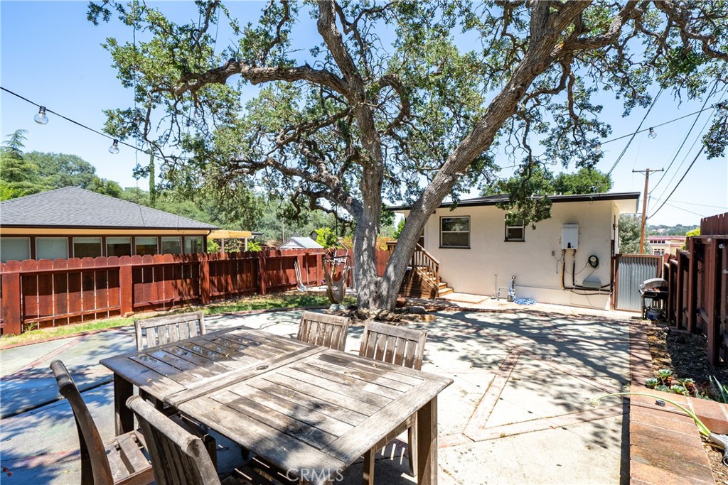 204 18th Street Paso Robles, CA 93446 - Photo 39 of 65 a view of a patio with table and chairs a barbeque with wooden fence and floor