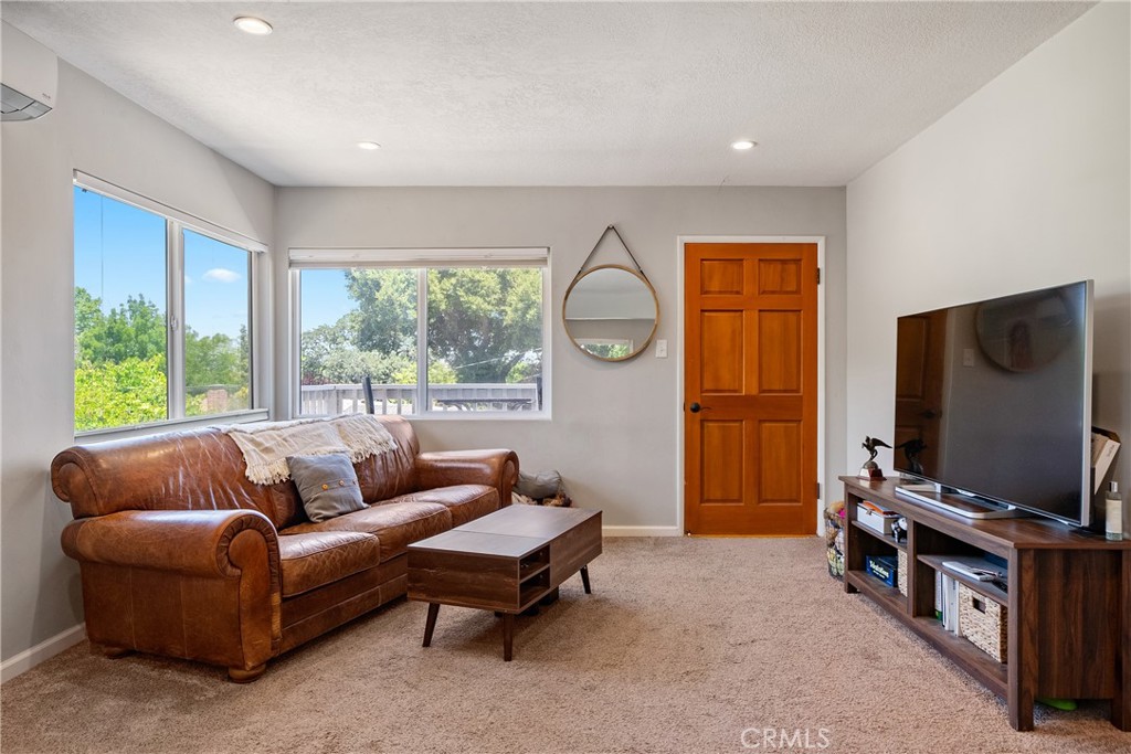204 18th Street Paso Robles, CA 93446 - Photo 47 of 65 a living room with furniture a flat screen tv and a window