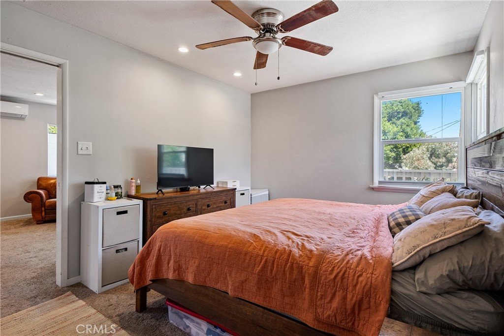 204 18th Street Paso Robles, CA 93446 - Photo 48 of 65 a bedroom with a bed and a chandelier