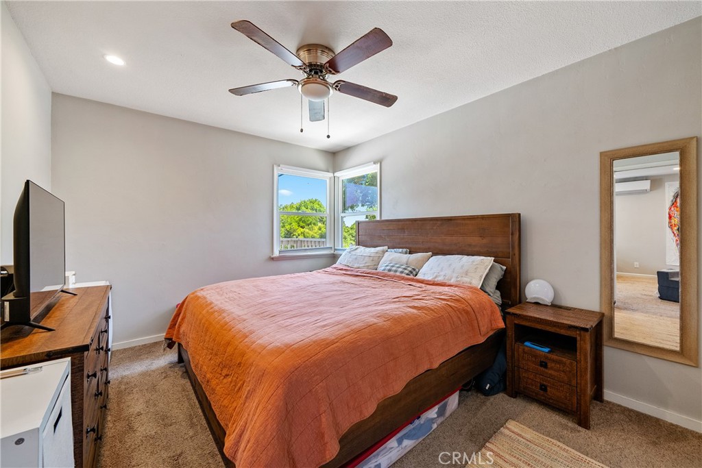 204 18th Street Paso Robles, CA 93446 - Photo 49 of 65 a bedroom with a bed and a chandelier