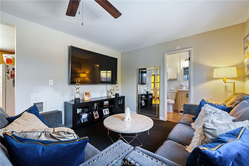 204 18th Street Paso Robles, CA 93446 - Photo 55 of 65 a living room with furniture and a flat screen tv