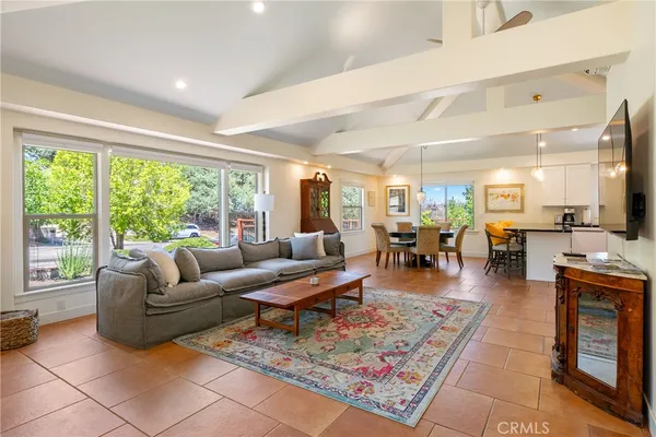 a living room with furniture wooden floor and a flat screen tv