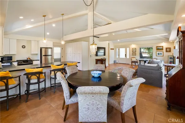 a kitchen with granite countertop white cabinets white appliances and a sink