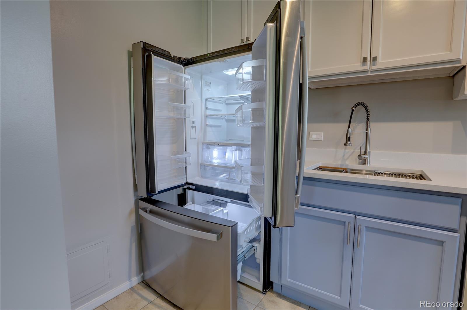 2100 Franklin Street, Unit 8 Denver, CO 80205 - Photo 11 of 29 a room with cabinets and a sink