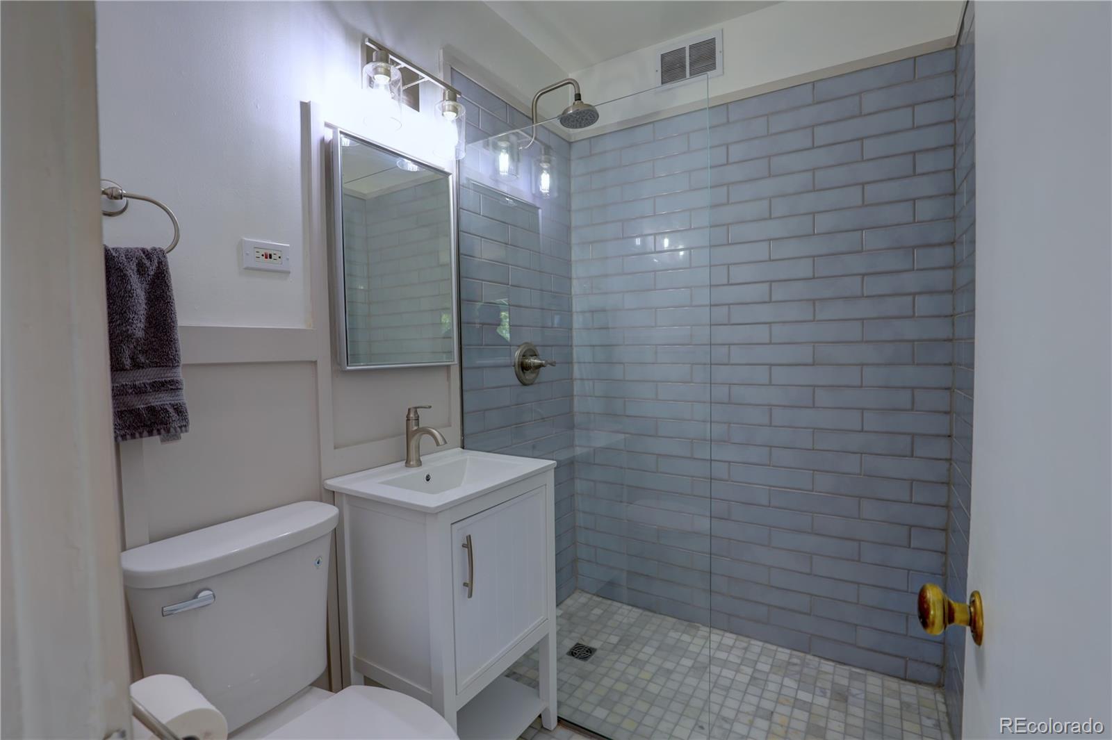 2100 Franklin Street, Unit 8 Denver, CO 80205 - Photo 14 of 29 a bathroom with a sink mirror toilet and shower