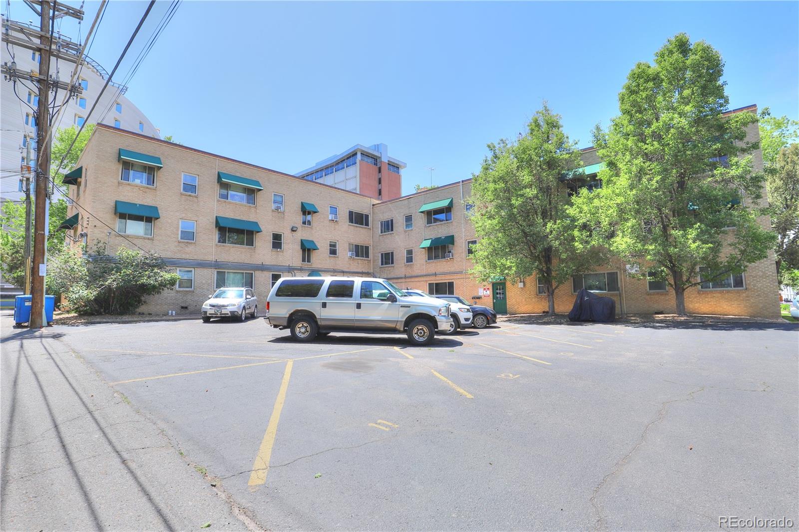 2100 Franklin Street, Unit 8 Denver, CO 80205 - Photo 21 of 29 a car parked in front of a building