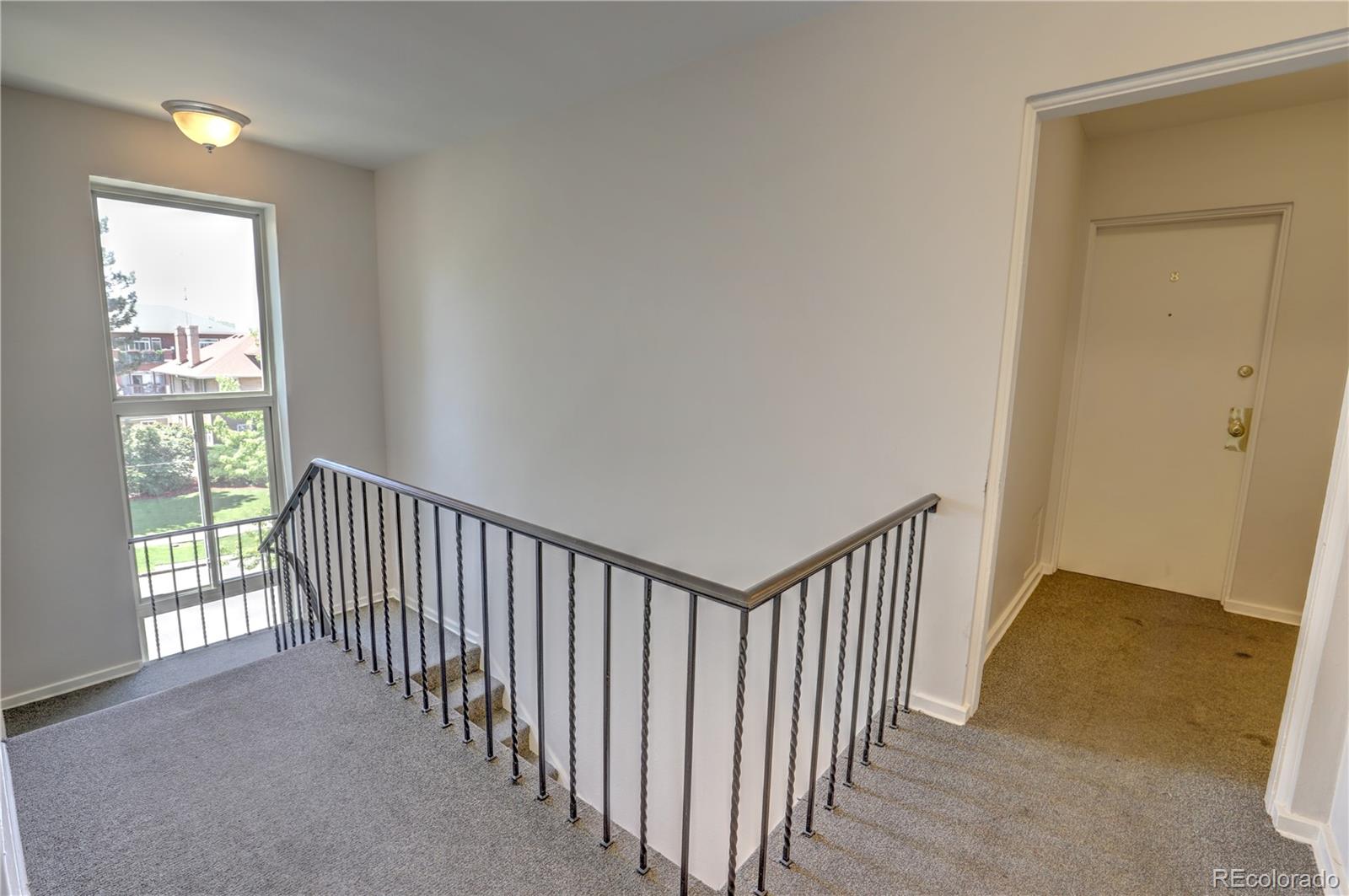 2100 Franklin Street, Unit 8 Denver, CO 80205 - Photo 4 of 29 a view of a hallway with a window