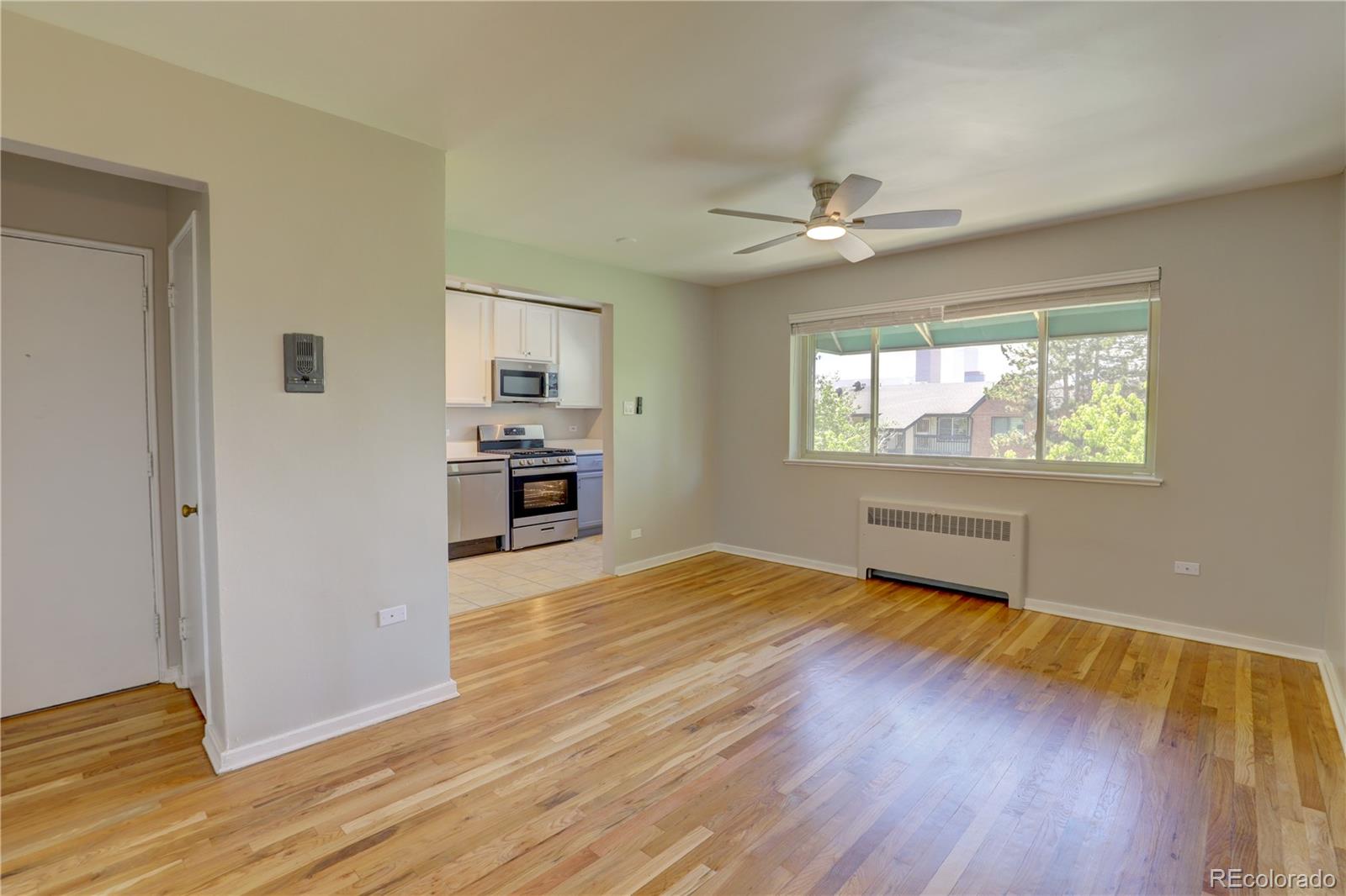 2100 Franklin Street, Unit 8 Denver, CO 80205 - Photo 5 of 29 a view of empty room with wooden floor and fan