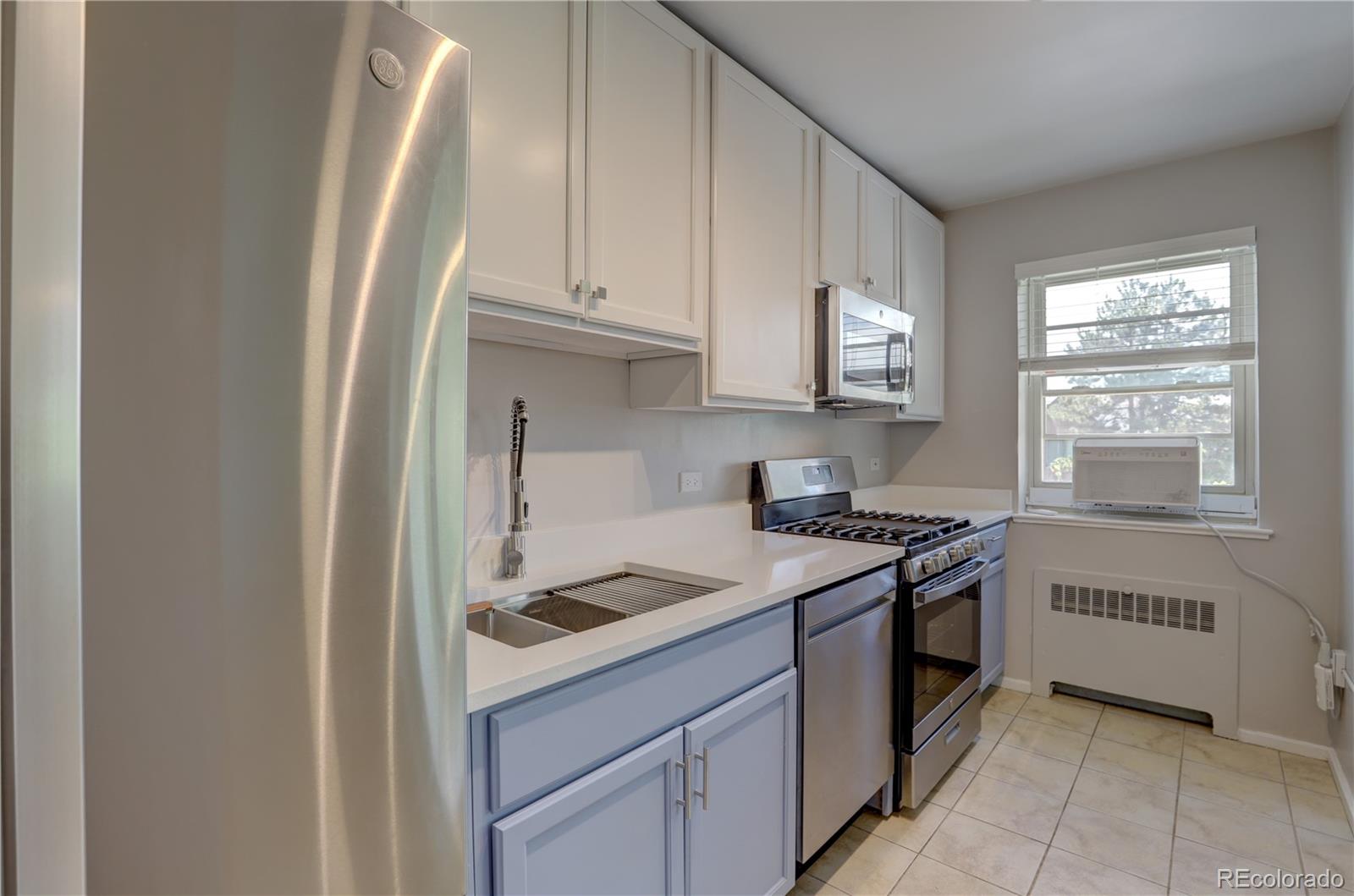 2100 Franklin Street, Unit 8 Denver, CO 80205 - Photo 10 of 29 a kitchen with a stove and a refrigerator