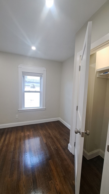 7 Samoset Street, Unit 2 Boston, MA 02124 - Photo 5 of 12 an empty room with wooden floor and a window