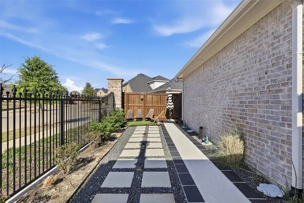 a view of a brick house with a small yard