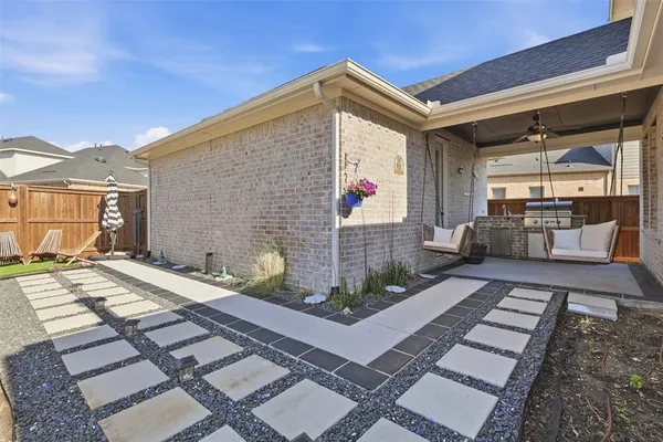a view of a backyard with sitting area