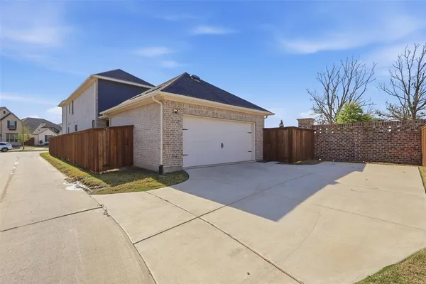 a view of a house with a yard and garage