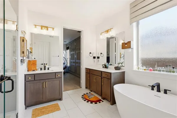 a bathroom with a tub sink and mirror