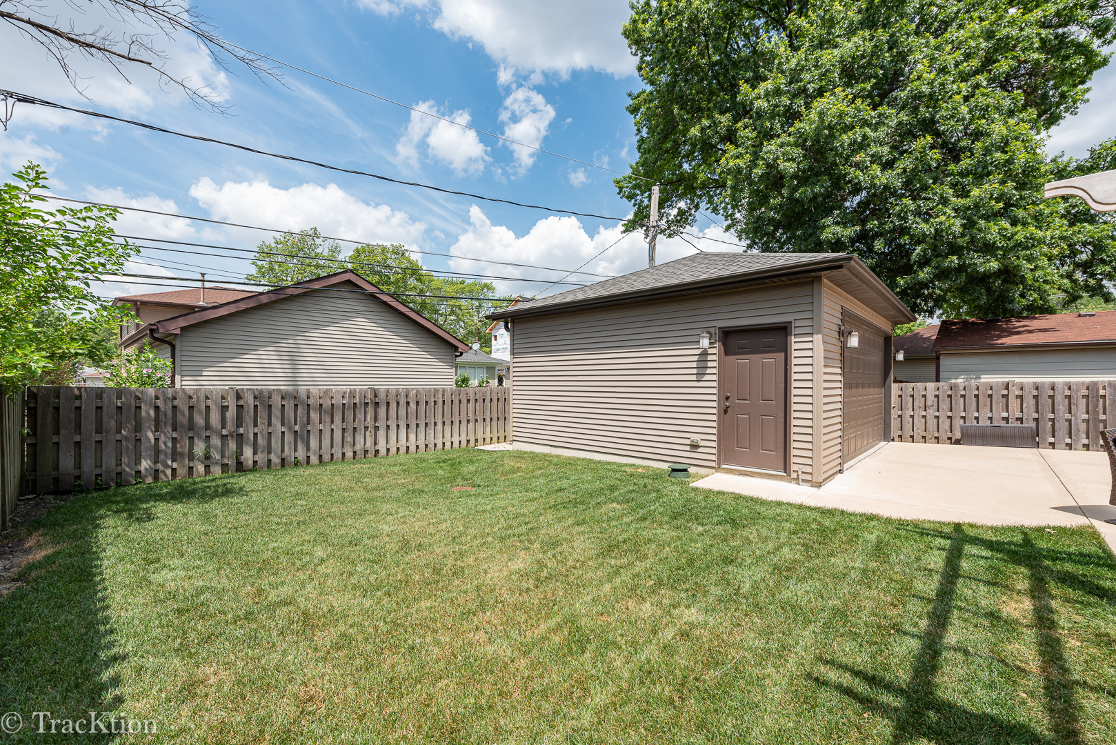 532 North Rose Avenue Park Ridge, IL 60068 - Photo 47 of 48 a yellow and red house with a small yard and wooden fence