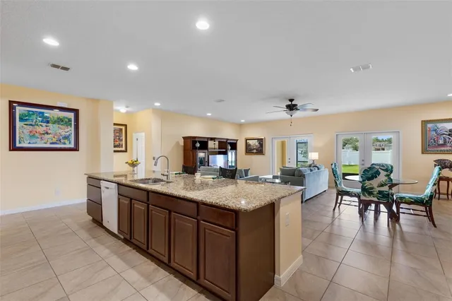 a large kitchen with kitchen island a sink table and chairs