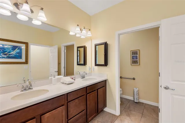 a bathroom with a double vanity sink and a mirror
