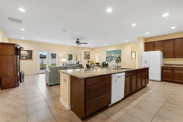 a kitchen with stainless steel appliances granite countertop a refrigerator and a stove
