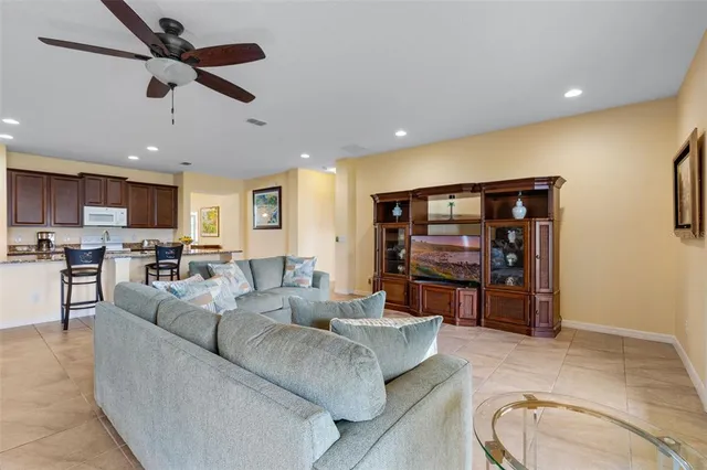 a living room with furniture and kitchen view