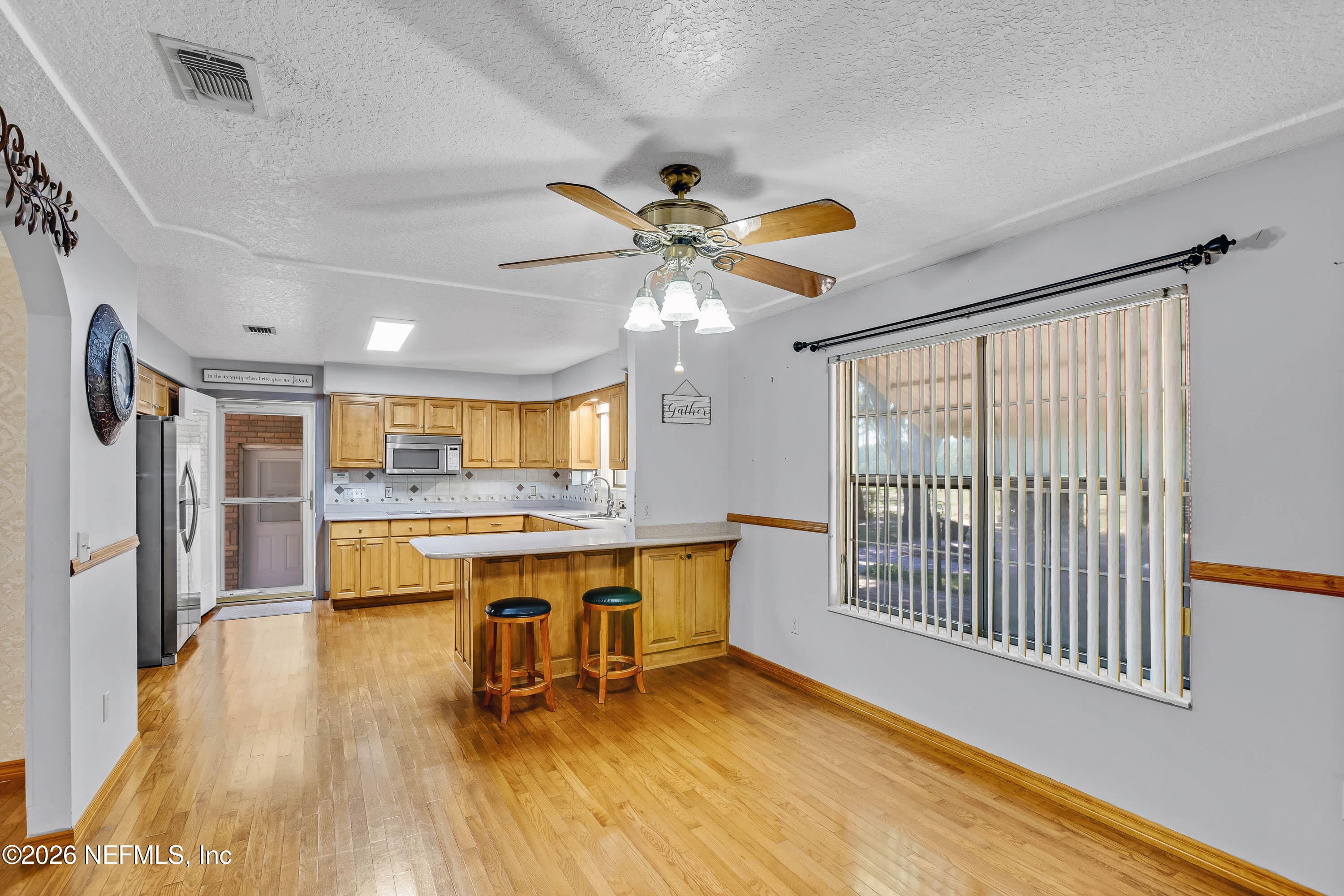 289 Chesser Road Interlachen, FL 32148 - Photo 13 of 63 a view of a livingroom with furniture a ceiling fan and wooden floor