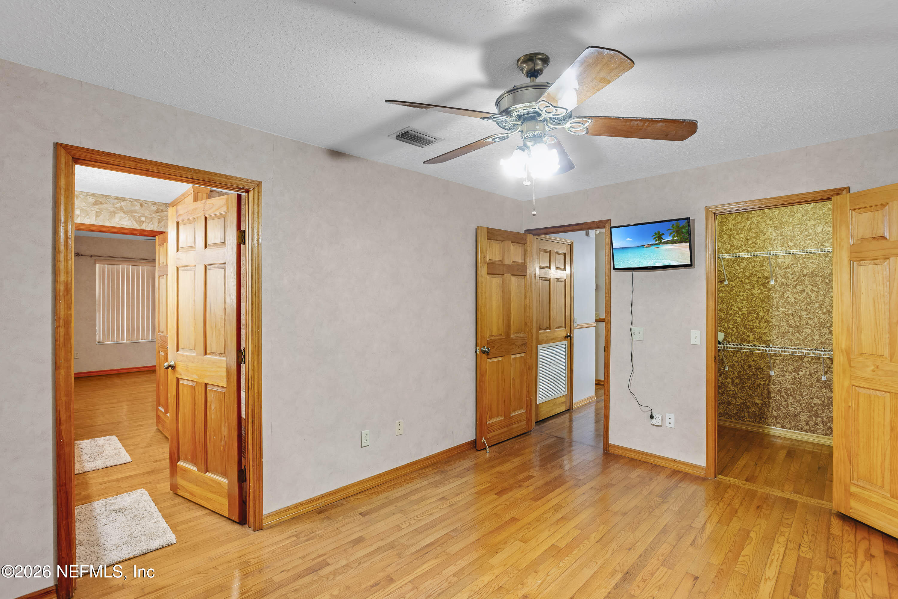 289 Chesser Road Interlachen, FL 32148 - Photo 18 of 63 a view of an empty room with wooden floor and a window