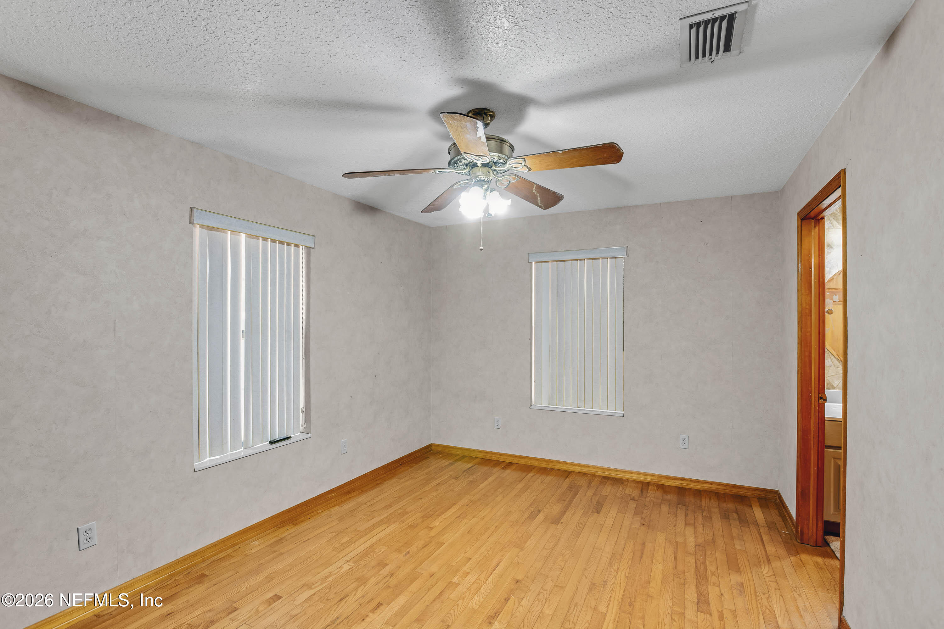 289 Chesser Road Interlachen, FL 32148 - Photo 19 of 63 wooden floor in an empty room with a window