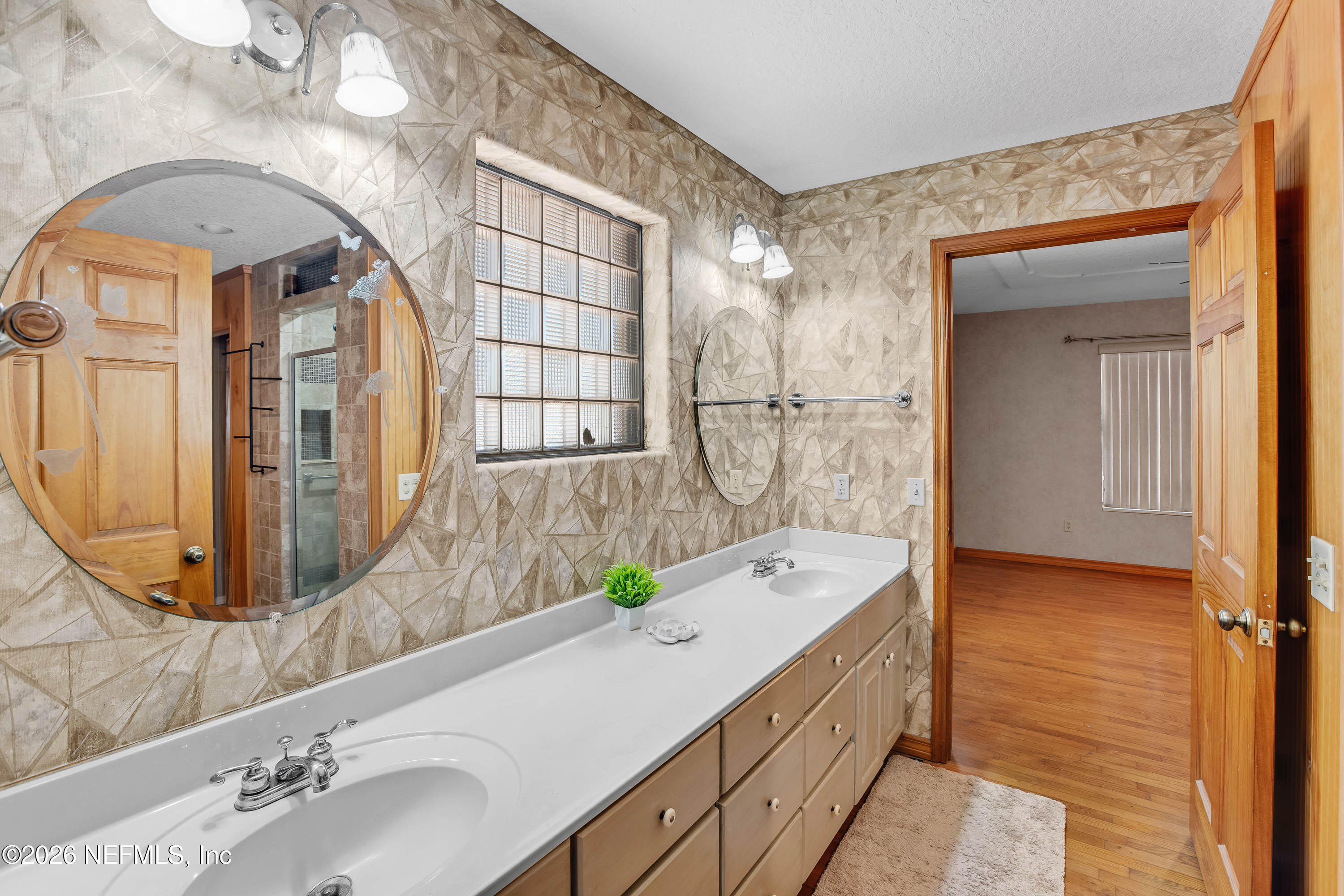 289 Chesser Road Interlachen, FL 32148 - Photo 22 of 63 a bathroom with a double vanity sink mirror and bathtub