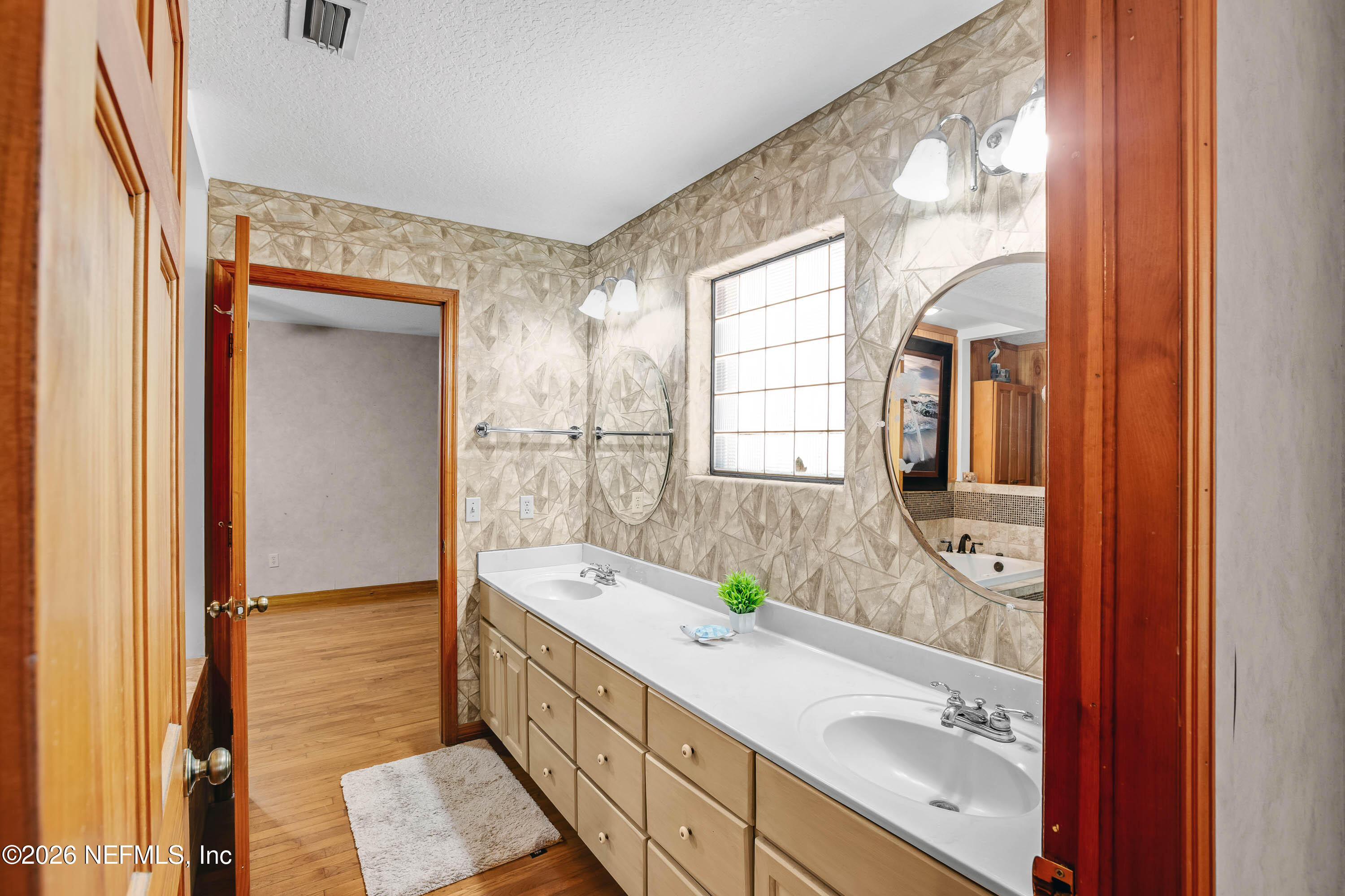 289 Chesser Road Interlachen, FL 32148 - Photo 25 of 63 a bathroom with a granite countertop tub sink and mirror