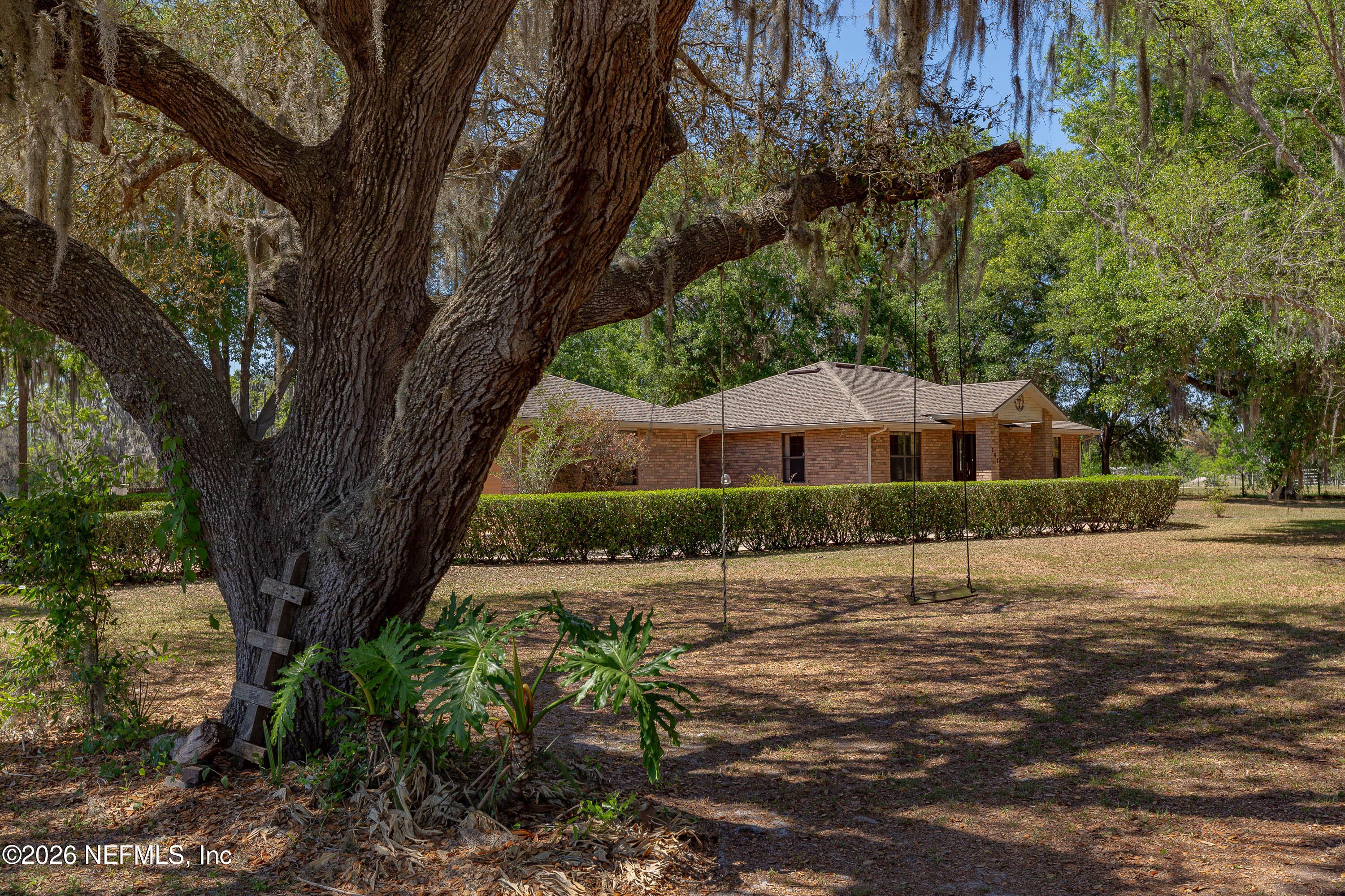 289 Chesser Road Interlachen, FL 32148 - Photo 34 of 63 a front view of a house with a garden